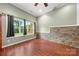 Bonus room with a stone accent wall, wood-look tile and a large window at 444 Snapdragon Dr, Clover, SC 29710