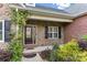 Inviting front entrance with stone accents, a dark wood door, and decorative climbing vines at 444 Snapdragon Dr, Clover, SC 29710