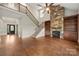 Inviting living room with a stone fireplace, built-in bookshelves, and hardwood flooring at 444 Snapdragon Dr, Clover, SC 29710