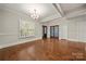 Bright living room with hardwood floors, neutral paint, large windows, and modern chandelier at 444 Snapdragon Dr, Clover, SC 29710
