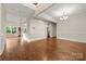 Open-concept living room with beautiful hardwood floors and a modern chandelier at 444 Snapdragon Dr, Clover, SC 29710
