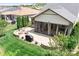 Aerial view of the backyard featuring patio with an outdoor kitchen, fireplace and screened-in porch with ceiling fans at 4902 Looking Glass Trl, Denver, NC 28037