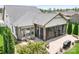 Aerial view showcasing the backyard with the screened-in patio with BBQ, fireplace and manicured landscaping at 4902 Looking Glass Trl, Denver, NC 28037