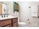 Cozy bathroom featuring a wood vanity with marble countertop, decorative towels, and dark bronze fixtures at 4902 Looking Glass Trl, Denver, NC 28037
