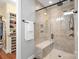 Modern bathroom with a glass enclosed shower featuring beige tiling, a shower bench, and a view into a walk-in closet at 4902 Looking Glass Trl, Denver, NC 28037