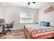 Bright bedroom featuring a bed with decorative pillows and desk underneath a window with slatted blinds at 4902 Looking Glass Trl, Denver, NC 28037