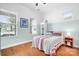 Bright bedroom featuring a colorful quilt bed, hardwood floors and large windows allowing ample natural light at 4902 Looking Glass Trl, Denver, NC 28037