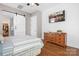A bedroom featuring a striped bedspread, wood dresser with TV, and a sliding barn door to a walk-in closet at 4902 Looking Glass Trl, Denver, NC 28037