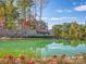 Scenic Trilogy Lake Norman entrance with stone signage, water feature, and colorful landscaping at 4902 Looking Glass Trl, Denver, NC 28037