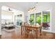 Open-concept dining room features a wooden table, modern lighting and sliding doors to an outdoor patio at 4902 Looking Glass Trl, Denver, NC 28037