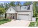 Charming home featuring a two-car garage, well-manicured lawn, and a inviting front porch at 4902 Looking Glass Trl, Denver, NC 28037