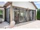 Charming screened-in patio with an adjacent outdoor patio complete with an Adirondack chair and fireplace at 4902 Looking Glass Trl, Denver, NC 28037