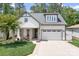 Charming home featuring a two-car garage, well-manicured lawn, and a inviting front porch at 4902 Looking Glass Trl, Denver, NC 28037