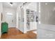 Entryway showcasing hardwood floors, barn doors, and a built-in bookcase at 4902 Looking Glass Trl, Denver, NC 28037