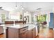 Spacious kitchen with island, stainless steel appliances, and sink with views of dining and living area at 4902 Looking Glass Trl, Denver, NC 28037