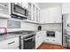 Modern kitchen features stainless steel appliances, granite countertops and custom white cabinets at 4902 Looking Glass Trl, Denver, NC 28037