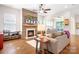 Cozy living room featuring a stone fireplace, hardwood floors, and comfortable seating with natural light at 4902 Looking Glass Trl, Denver, NC 28037