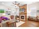 Inviting living room with fireplace and built-in shelving, offering a cozy atmosphere and plenty of storage at 4902 Looking Glass Trl, Denver, NC 28037