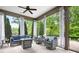 Relaxing screened-in patio with comfortable seating, a ceiling fan, and view of the landscaped backyard at 4902 Looking Glass Trl, Denver, NC 28037
