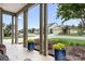 Covered porch framed by columns with colorful flower pots adds charm and curb appeal at 4902 Looking Glass Trl, Denver, NC 28037