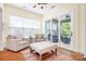 Bright sunroom features comfortable seating, hardwood floors, and sliding glass doors leading to an outdoor patio at 4902 Looking Glass Trl, Denver, NC 28037
