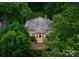 Stunning aerial view of beautiful luxury home, surrounded by mature trees at 5030 Hardison Rd, Charlotte, NC 28226