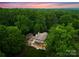 Expansive estate nestled among a dense canopy of trees, offering privacy and tranquility at 5030 Hardison Rd, Charlotte, NC 28226