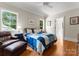 Cozy bedroom featuring wood floors, windows, and a comfy chair with ottoman at 5030 Hardison Rd, Charlotte, NC 28226
