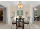 A bright breakfast nook boasts ample natural light, a decorative chandelier, and tile floors at 5030 Hardison Rd, Charlotte, NC 28226