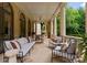 Spacious covered patio with elegant columns and comfortable seating area at 5030 Hardison Rd, Charlotte, NC 28226