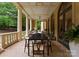 Spacious covered patio with elegant columns, ceiling fan, and comfortable dining area at 5030 Hardison Rd, Charlotte, NC 28226