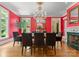 A vibrant dining room is bathed in natural light and features a decorative fireplace and chandelier at 5030 Hardison Rd, Charlotte, NC 28226