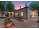 Elegant home exterior with a charming courtyard, garden, and stone accents at 5030 Hardison Rd, Charlotte, NC 28226