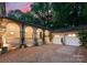 Charming exterior featuring arched walkways, a detached garage, and a beautifully graveled driveway at 5030 Hardison Rd, Charlotte, NC 28226