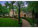 Lush greenery surrounds this impressive residence and its manicured landscaping at 5030 Hardison Rd, Charlotte, NC 28226