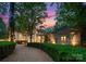 Stately home with manicured hedges, a circular driveway, and timeless architecture at 5030 Hardison Rd, Charlotte, NC 28226