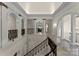 Grand foyer with architectural columns, decorative railings, and arched doorways providing a sophisticated entrance at 5030 Hardison Rd, Charlotte, NC 28226
