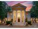 Impressive facade showcasing stately columns, an elegant entrance, and meticulous landscaping at twilight at 5030 Hardison Rd, Charlotte, NC 28226