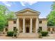 Stately home with grand entrance featuring columns, a symmetrical facade, and manicured landscaping at 5030 Hardison Rd, Charlotte, NC 28226