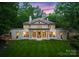 Stunning front exterior view of home with a lush lawn and a beautiful sunset backdrop at 5030 Hardison Rd, Charlotte, NC 28226