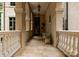 Inviting covered front porch with stone flooring, pillars, and elegant lighting fixtures at 5030 Hardison Rd, Charlotte, NC 28226