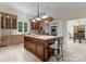 An island kitchen offers a butcher block island and stainless appliances. The kitchen looks out to the dining area at 5030 Hardison Rd, Charlotte, NC 28226