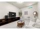Comfortable living room with plush sofas, a glass coffee table, and a large entertainment center at 5030 Hardison Rd, Charlotte, NC 28226