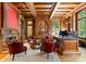A wood-paneled office with coffered ceiling, fireplace, and custom built-ins offers rich styling at 5030 Hardison Rd, Charlotte, NC 28226