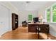 Bright office space with hardwood floors, large windows offering natural light, and a classic desk setup at 5030 Hardison Rd, Charlotte, NC 28226