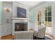Cozy sitting room with a decorative fireplace, plush chairs, and access to an outdoor patio at 5030 Hardison Rd, Charlotte, NC 28226