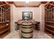 Rustic wine cellar with wooden wine racks and barrel table for enjoying wine tastings at 5030 Hardison Rd, Charlotte, NC 28226