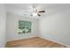 Bright bedroom features wood flooring, ceiling fan, and a sunlit window at 519 Jacobs Rdg, Fort Mill, SC 29715