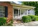 Inviting front porch with brick and siding, complemented by lush greenery at 519 Jacobs Rdg, Fort Mill, SC 29715