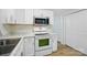 Bright kitchen featuring white cabinets, range, and stainless steel microwave at 519 Jacobs Rdg, Fort Mill, SC 29715